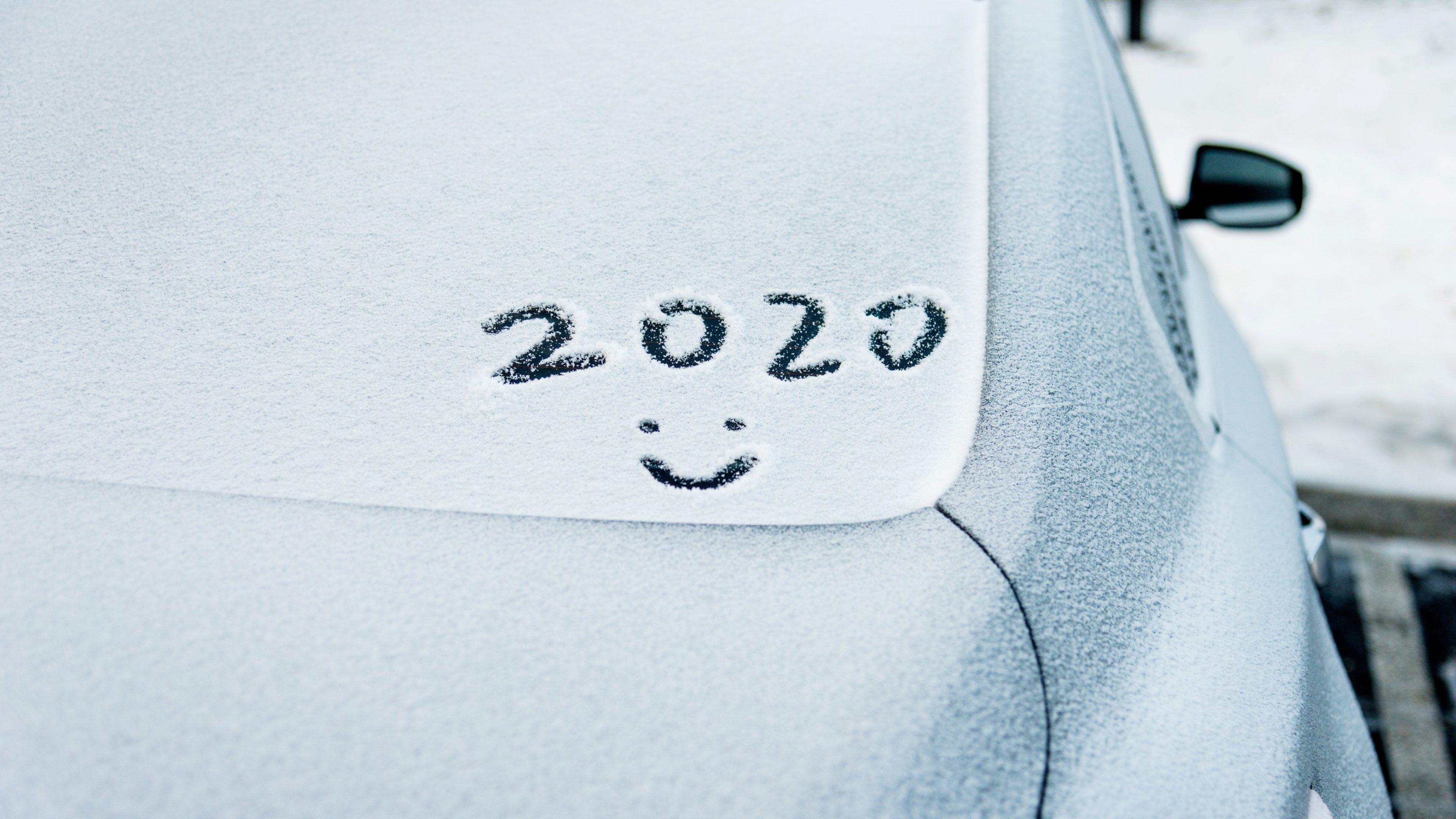 New year 2020 written on car windshield.