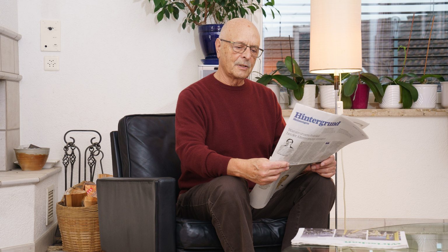 Meinrad Graf entspannt in seinem Wohnzimmer-Sessel und liest die Zeitung. Das Bild vermittelt ein Gefühl von Ruhe und Gemütlichkeit in den eigenen vier Wänden. 